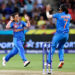 Poonam Yadav (left) celebrates with teammate Harmanpreet Kaur after taking the wicket of Australia's Jess Jonassen during the first game of the Women's T20 Cricket World Cup in Sydney on Friday