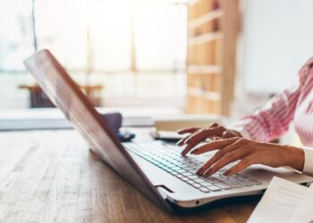 Woman working from home using notebook computer. | Photo Credit: undrey