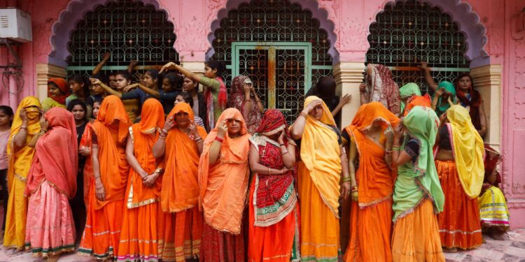 Women wait to take part in Huranga, a game played between men and women, a day after Holi at Dauji temple near the northern city of Mathura, India, on March 9.