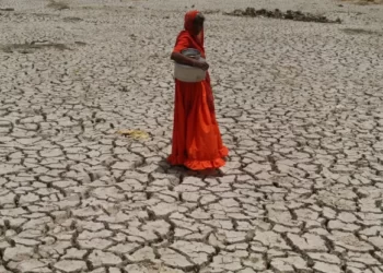 A woman crossing dry Sabarmati riverbed in India. India’s rural women are bearing the brunt of climate related shocks like severe drought and extreme weather events,